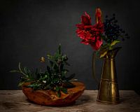 Stilleben mit Olivenzweigen und roter Blume