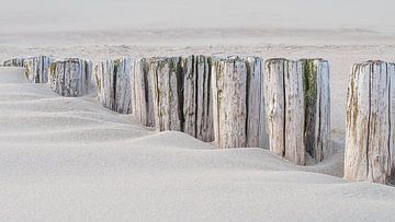 Calm rhythm on the beach: Breakwaters gradually disappear into the sand by Marjolijn van den Berg