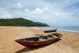 Fishing boats on a lonely Caribbean beach by Bettina Schnittert