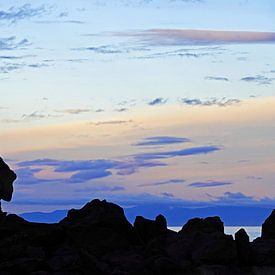Sunset on the rocks of Kaiteriteri in New Zealand by Aagje de Jong