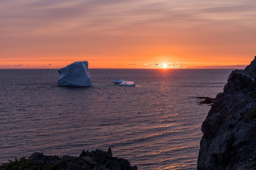 Iceberg off the coast of Twillingate Newfoundland during sunset by Menno Schaefer