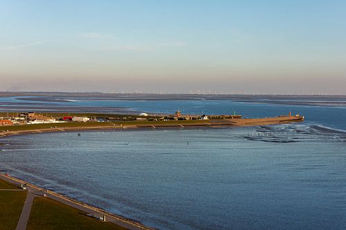 Bay of Büsum at sunset with harbour, low tide and mudflat walkers