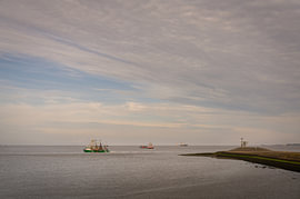 Ships sail past the Oterdummer pier