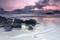 Rocks on snowy beach