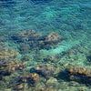 Blue sea water, rocks and gentle waves 2 by Adriana Mueller