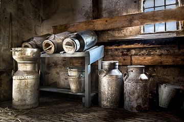 Collection of milk cans in a barn.