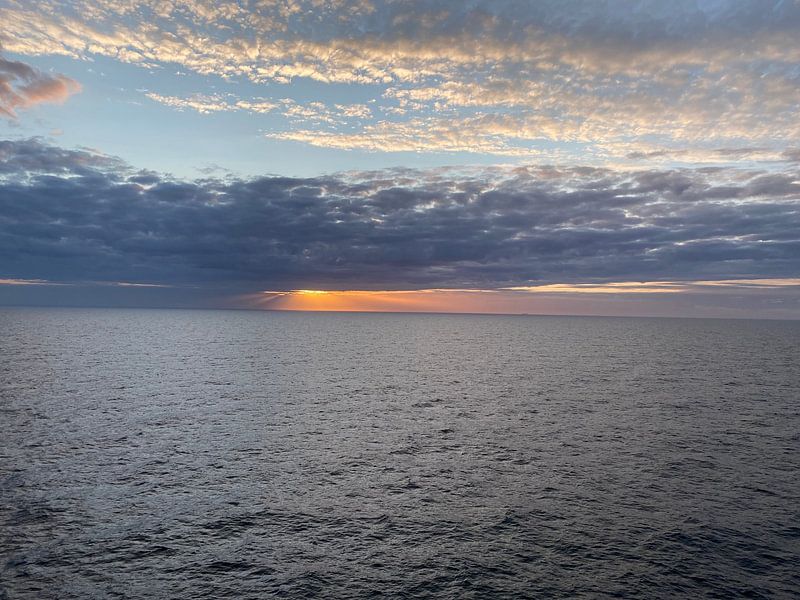 Sunset behind the clouds. by Marco Dekkers