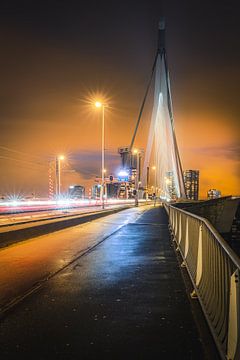 The Erasmus Bridge in Rotterdam Holland with traffic in the evening