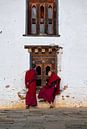 Monks peep through a window at a monastery in Bhutan by Teun Janssen thumbnail