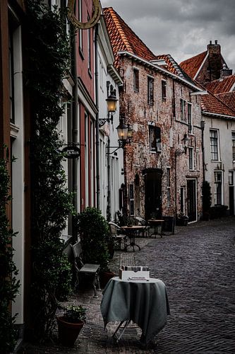 A solitary, laid table in one of Deventer’s historic streets in the Netherlands by Koen Lipman