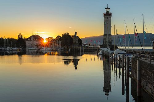 Lindau harbour with lighthouse at sunrise at Lake Constance