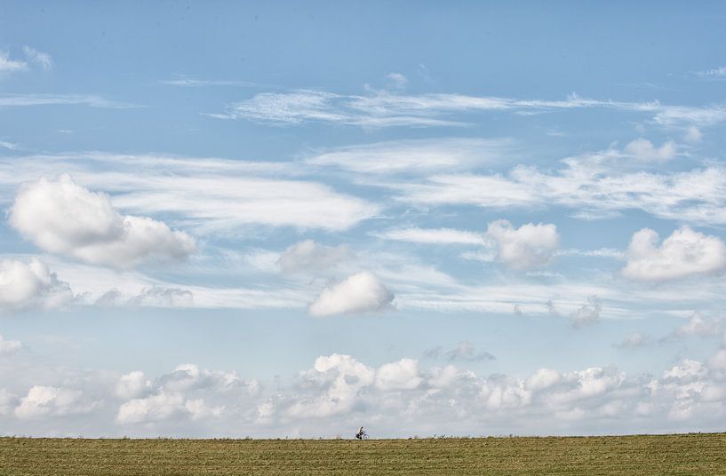 Cyclist on the dike near Lent by StudioSchulteSchultz