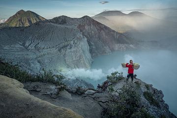 Portrait of a sulphur miner at the crater of the Ijen volcano by Anges van der Logt