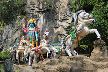 Hindu god with horse-drawn carriage in front of the Ramayana cave by kall3bu