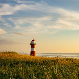 Sunset at the lighthouse of Westkapelle, Zeeland by Just Go Global