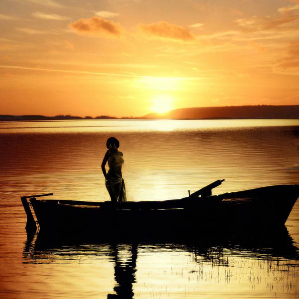 Woman in boat at sunset by Cor Heijnen