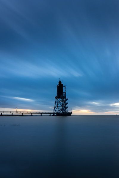 Lighthouse on the North Sea at sunset by Nils Steiner