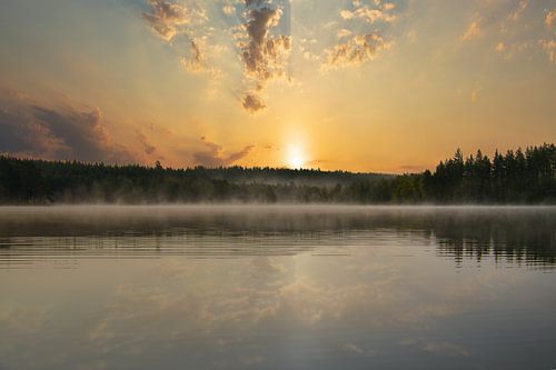 Sunrise with fog forming over a lake in Sweden, at dawn