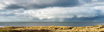 Panoramic view of a cloud formation with winter rain and hail storm off the Scheveningen coast