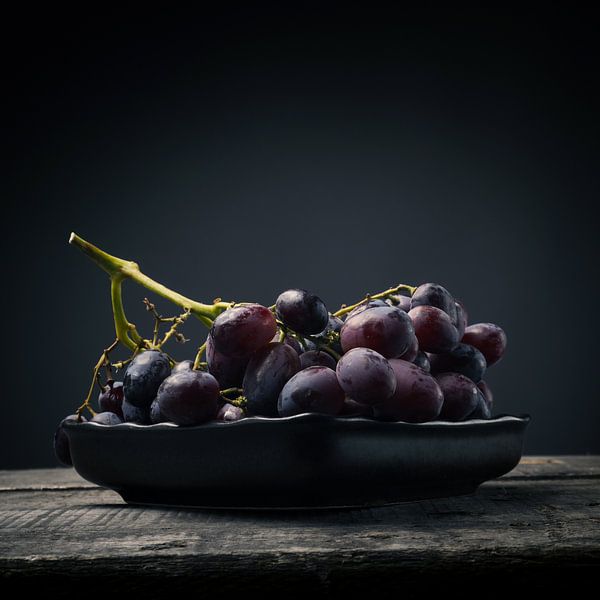 Red grapes on a wooden table by Andreas Berheide Photography