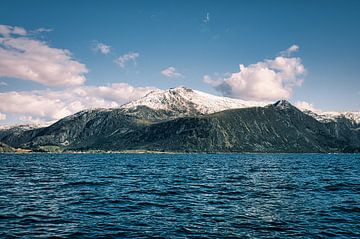 Western Cape in Norway. Fjord and sea with clouds and mountains on the coast by Martin Köbsch