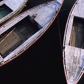 Four slender rowing boats. by Dick Termond