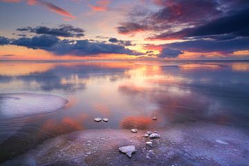 Winter landscape on the IJsselmeer at Workum with a colourful sunset by Bas Meelker