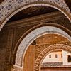 Arches with detailed stucco work in Nasrid palaces in the Alhambra, Granada by Melissa Peltenburg