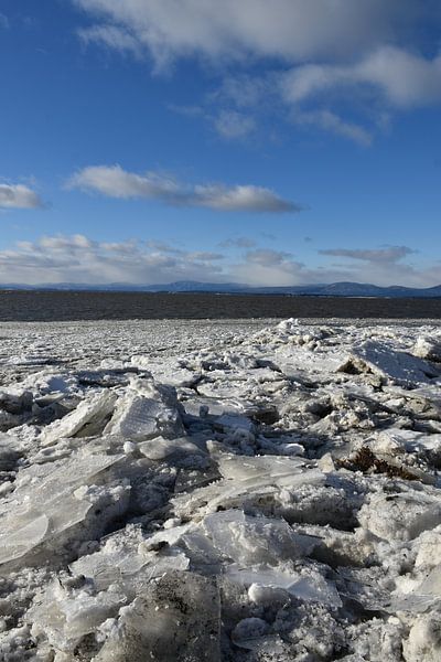 The river in winter under blue skies by Claude Laprise