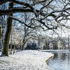 Borg Nienoord with pond in front of it in the snow by R Smallenbroek