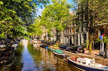 Houseboats in canal in Amsterdam by Dieter Walther