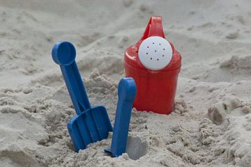 Children's toys in the sandbox by Norbert Sülzner