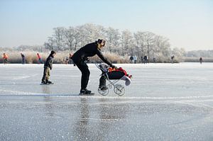 Mother with child in pram on ice by Merijn van der Vliet