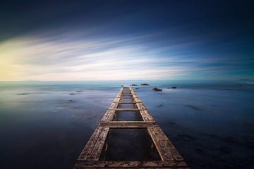 Wooden pier remains in a blue sea. Long Exposure. by Stefano Orazzini