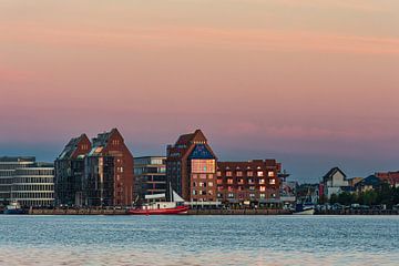 View over the Warnow River to the Hanseatic City of Rostock in the evening by Rico Ködder