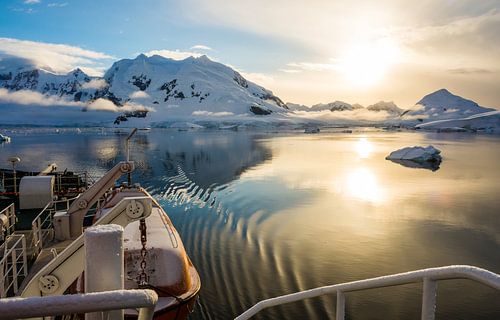 Silently gliding with a setting sun through Paradise Bay in Antarctica