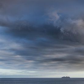 Ship on the ocean with heavy cloud cover by Harrie Muis
