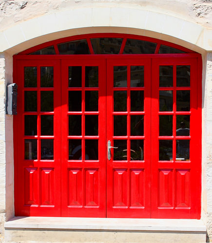 Classic red doors on a sunny façade