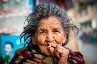 Old Nepalese woman smokes a cigarette