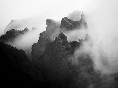 Mountain peaks in the clouds in black and white
