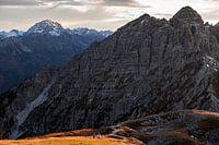 Hiking in the Alps in autumn. A couple walks up a mountain together