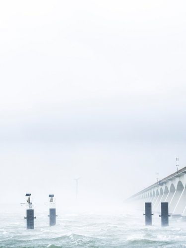 The beautiful zeeland bridge pictured in a different way during a bleak spring storm.