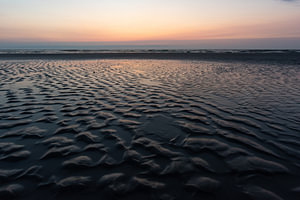 Colorful reflections on a wet beach
