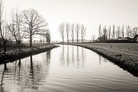 View over a narrow Dutch river in the winter season