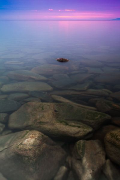 Stones in the clear water of Lake Baikal at sunset. by Michael Semenov