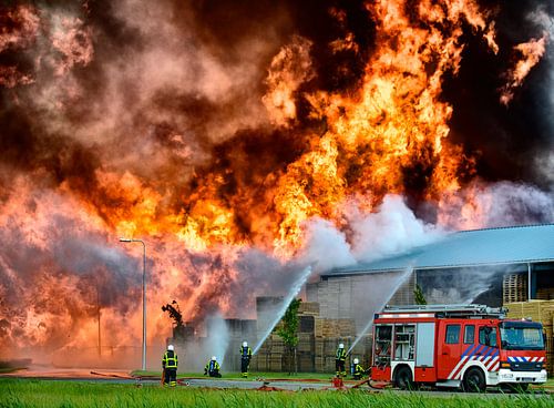 Fire engine in front of a fire in an industrial area by Sjoerd van der Wal Photography