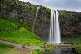 Islande - Chutes d'eau de Seljalandsfoss avec pont et rivière et sur adventure-photos