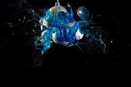 Blue Christmas ornament with contents explodes by Caroline Pleysier