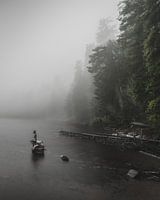 Landscape photo of a foggy misty lake with a statue of a mermaid