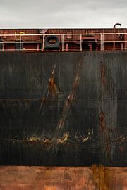 The bow of an ocean-going vessel moored at the quay of the harbor raw and drawn. by scheepskijkerhavenfotografie